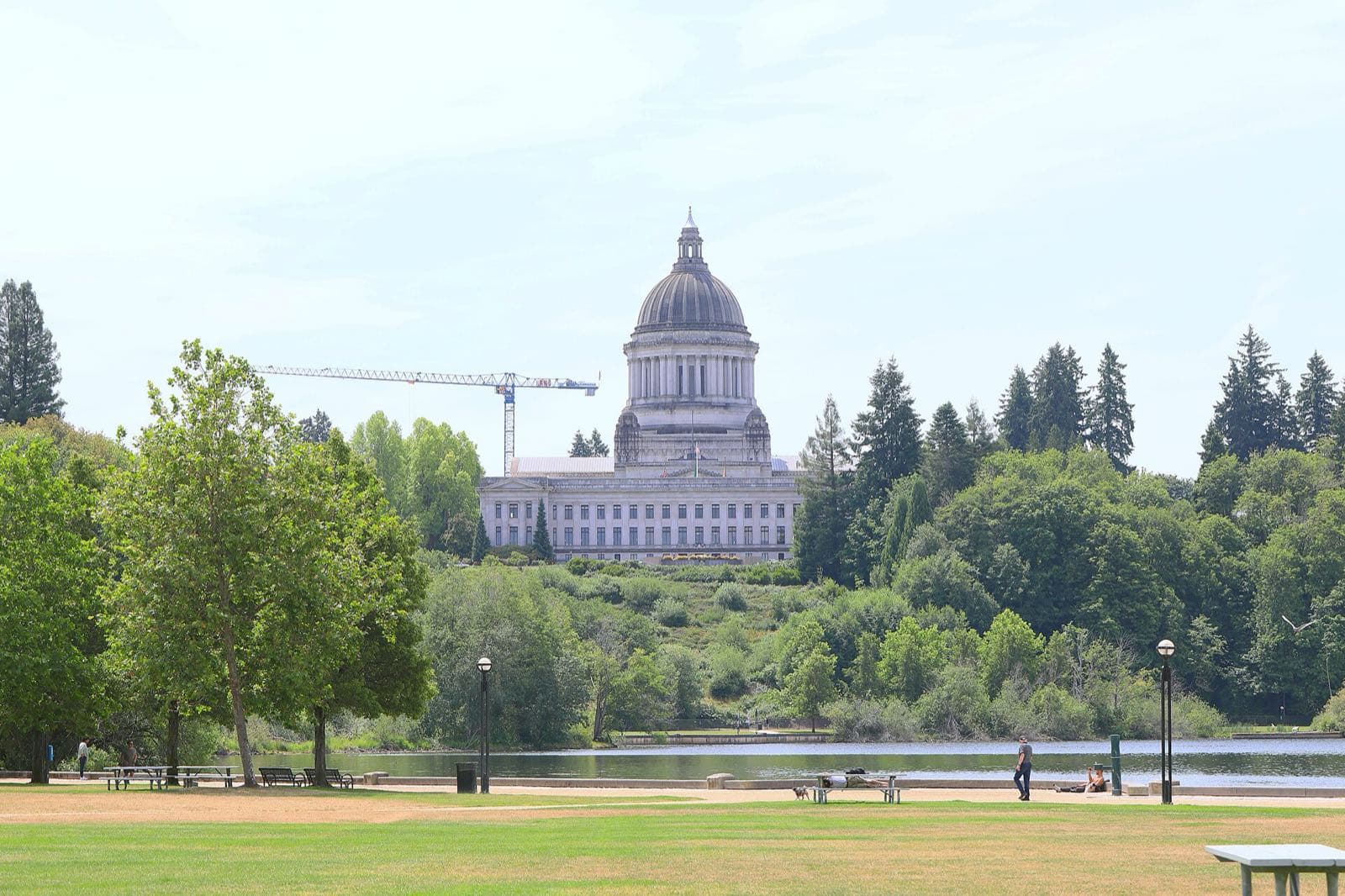The domed Washington State Capitol above the trees and shore of Capitol Lake in Olympia.